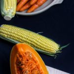 sliced squash near corn and carrots